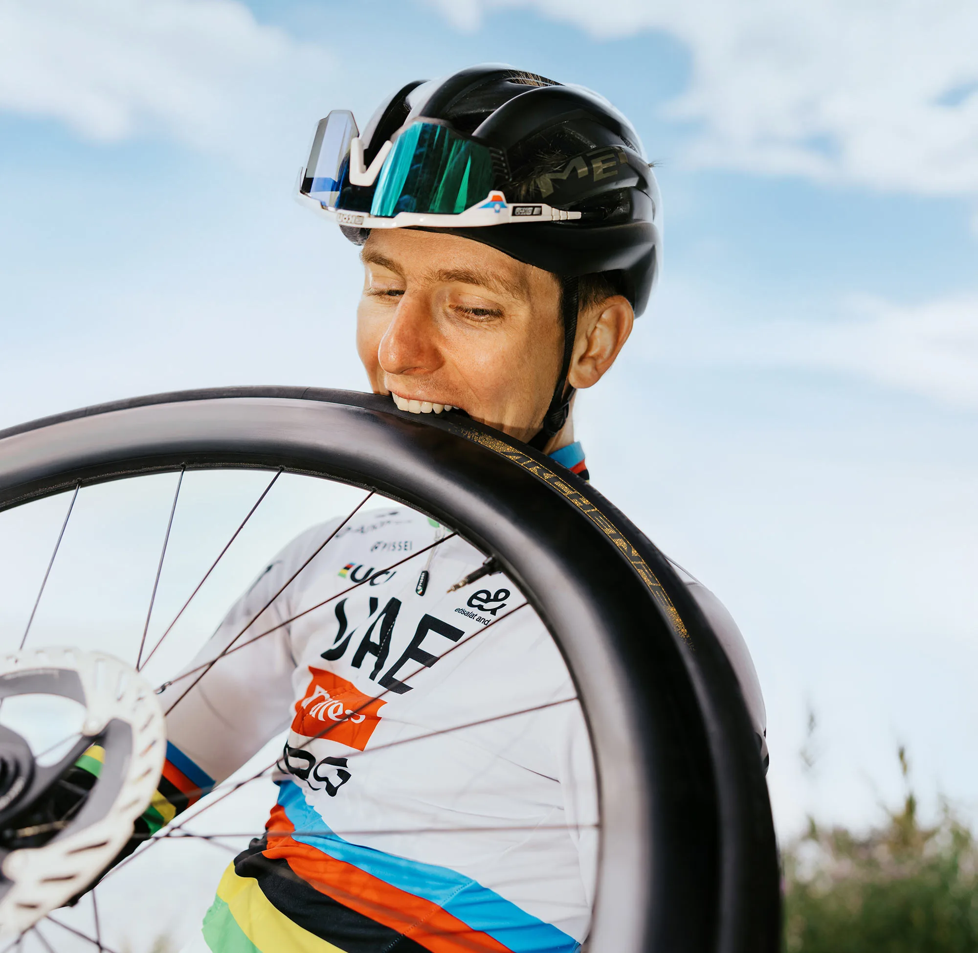 tadej pogacar biting into a continental archetype road bike race tire.